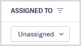 The Assigned to column on a Tasks view, showing one Unassigned cell.